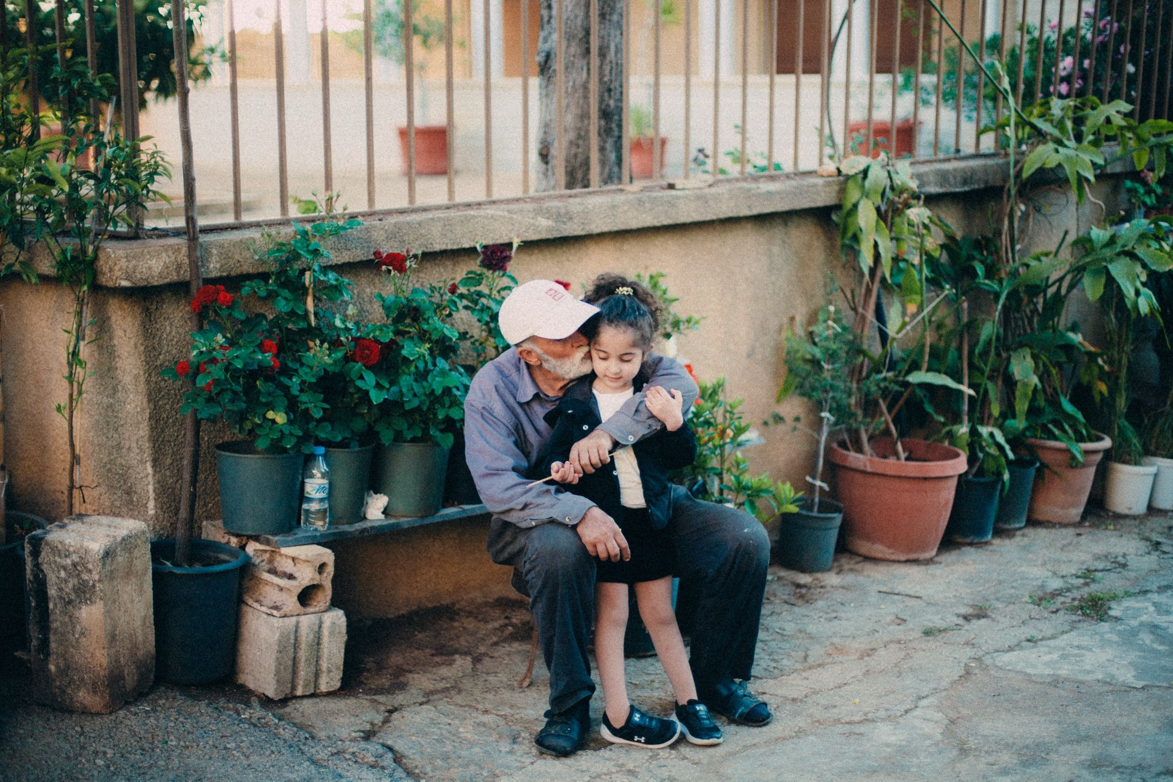A candid shot of my father's uncle and my cousin kissing him on the cheek. The town of Joun, Lebanon, 2025.