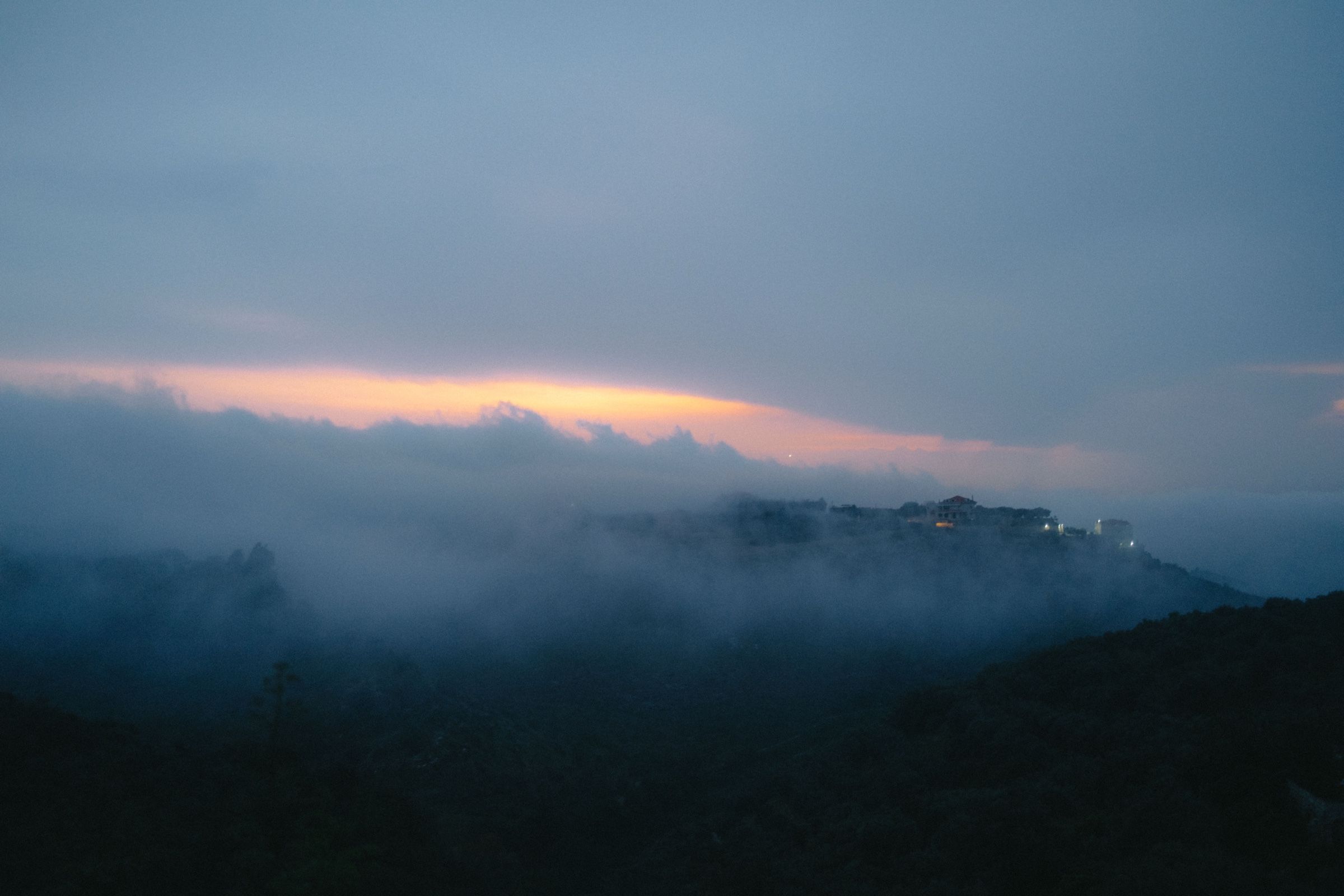 A photo taken from the rooftop of my home in Joun, Lebanon on a foggy sunset, 2024.