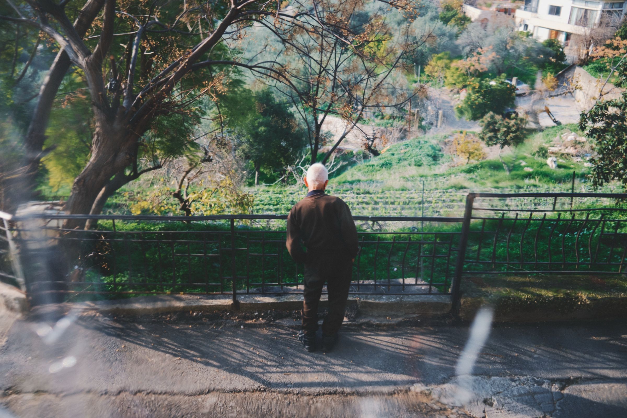 An old man, Salam — 82 and one of the oldest people in Joun — contemplates the green landscape. The town of Joun, Lebanon, 2025.